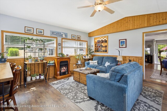 10470 Barnes Hwy, Eaton Rapids, MI 48827 - living area featuring a wainscoted wall, lofted ceiling, wood walls, wood finished floors, and ceiling fan