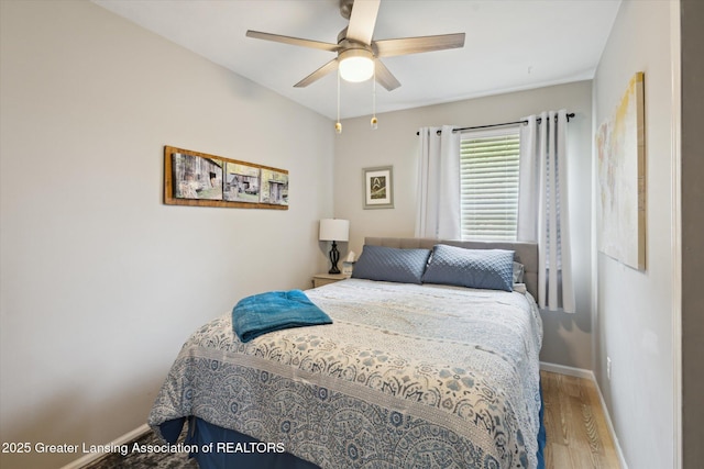 10470 Barnes Hwy, Eaton Rapids, MI 48827 - bedroom with wood finished floors, baseboards, and a ceiling fan