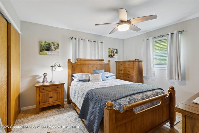 10470 Barnes Hwy, Eaton Rapids, MI 48827 - bedroom with a closet, wood finished floors, ceiling fan, and baseboards