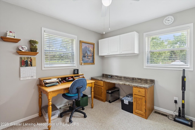 10470 Barnes Hwy, Eaton Rapids, MI 48827 - office area with light carpet, baseboards, and a ceiling fan