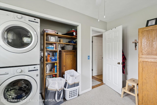 10470 Barnes Hwy, Eaton Rapids, MI 48827 - washroom with stacked washer and clothes dryer, carpet flooring, and baseboards