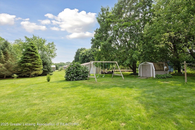10470 Barnes Hwy, Eaton Rapids, MI 48827 - view of grassy yard with a carport and a playground
