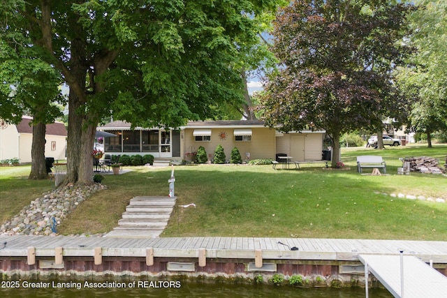 4951 Shore Ln, Perrinton, MI 48871 - back of house with a lawn, a sunroom, and a water view