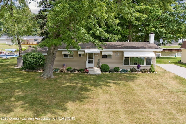 4951 Shore Ln, Perrinton, MI 48871 - ranch-style home with a front yard and a chimney