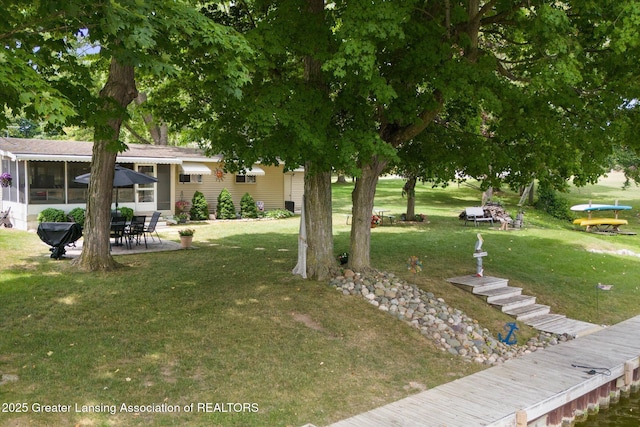 4951 Shore Ln, Perrinton, MI 48871 - view of grassy yard featuring a patio area