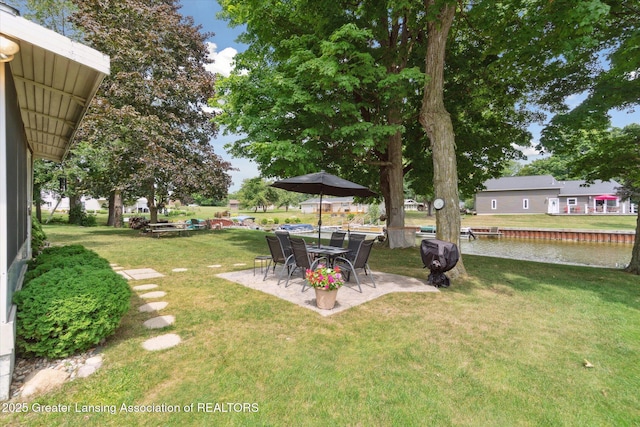 4951 Shore Ln, Perrinton, MI 48871 - view of green lawn with a patio and a water view