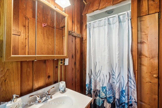 4951 Shore Ln, Perrinton, MI 48871 - full bathroom with vanity, a shower with curtain, and wood walls