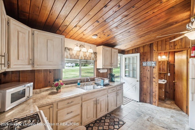 4951 Shore Ln, Perrinton, MI 48871 - kitchen with a sink, white appliances, vaulted ceiling, wooden ceiling, and wood walls