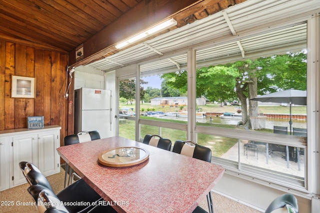 4951 Shore Ln, Perrinton, MI 48871 - dining area featuring wooden walls, wooden ceiling, and carpet flooring