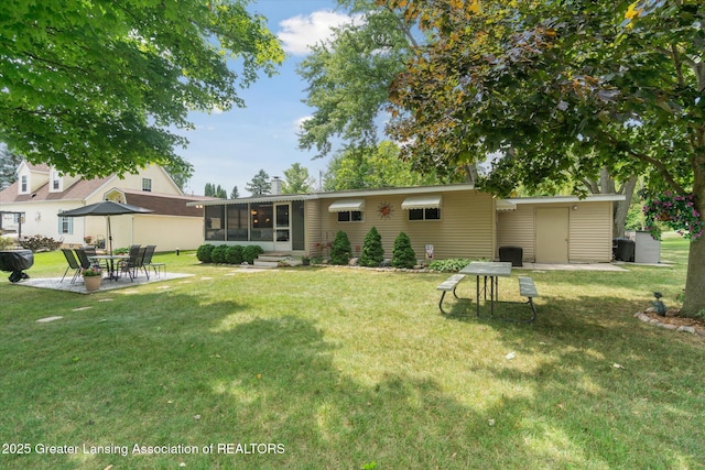 4951 Shore Ln, Perrinton, MI 48871 - back of house with a sunroom, a yard, and a patio area