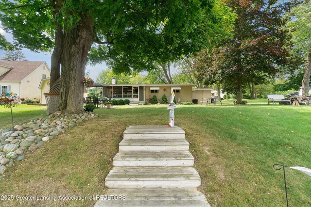 4951 Shore Ln, Perrinton, MI 48871 - single story home with a sunroom and a front lawn