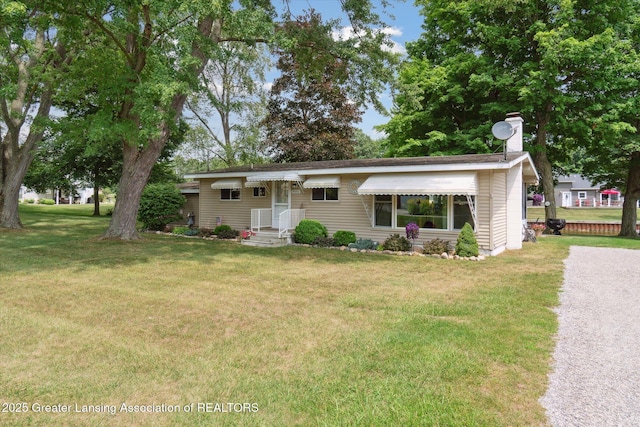 4951 Shore Ln, Perrinton, MI 48871 - ranch-style home featuring a front lawn and a chimney