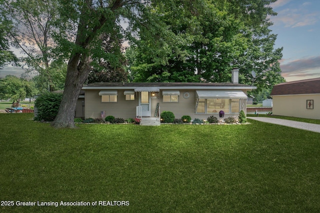 4951 Shore Ln, Perrinton, MI 48871 - single story home with a lawn and a chimney