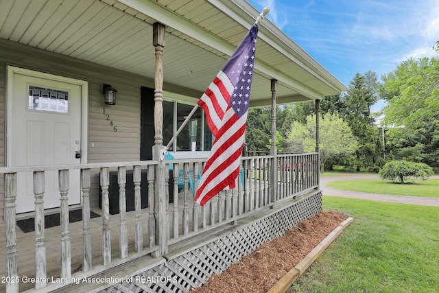 1246 House Rd N, Webberville, MI 48892 - property entrance featuring a porch and a lawn