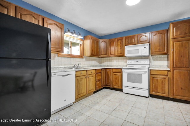 1246 House Rd N, Webberville, MI 48892 - kitchen featuring white appliances, light countertops, brown cabinetry, and tasteful backsplash