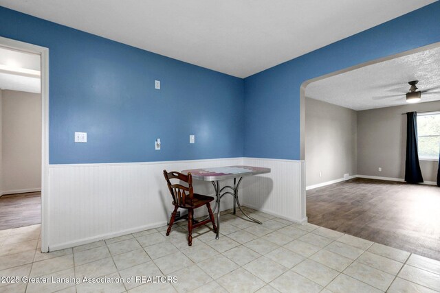 1246 House Rd N, Webberville, MI 48892 - dining space with wainscoting, a ceiling fan, and tile patterned floors