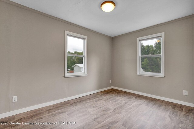 1246 House Rd N, Webberville, MI 48892 - empty room with wood finished floors and baseboards