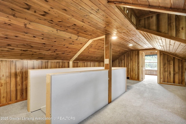 1246 House Rd N, Webberville, MI 48892 - additional living space with lofted ceiling, carpet flooring, and wood walls