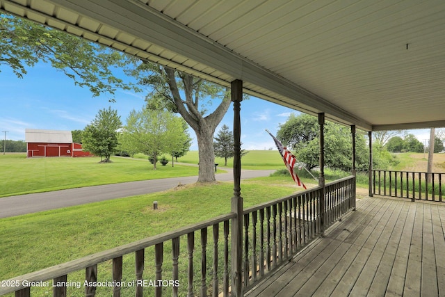 1246 House Rd N, Webberville, MI 48892 - deck with a lawn, a barn, and an outdoor structure