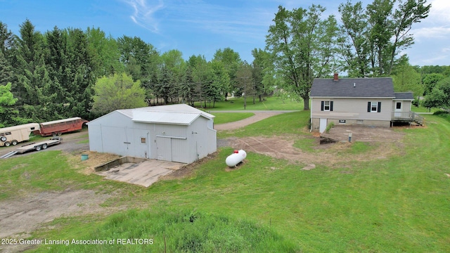 1246 House Rd N, Webberville, MI 48892 - view of grassy yard with an outdoor structure and a pole building
