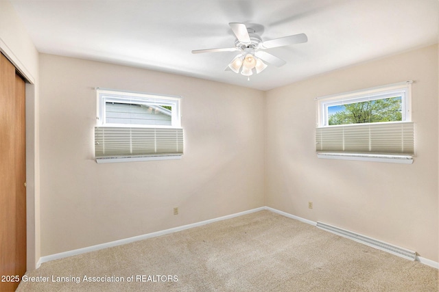 4810 Cherryland Dr, Lansing, MI 48910 - unfurnished bedroom featuring a baseboard radiator, a closet, carpet floors, and baseboards