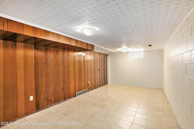 4810 Cherryland Dr, Lansing, MI 48910 - below grade area featuring concrete block wall and wooden walls