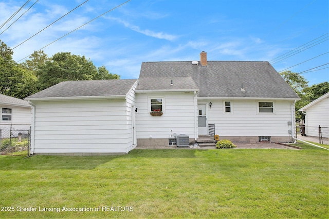 4810 Cherryland Dr, Lansing, MI 48910 - back of house with a chimney, central AC unit, a shingled roof, and a patio