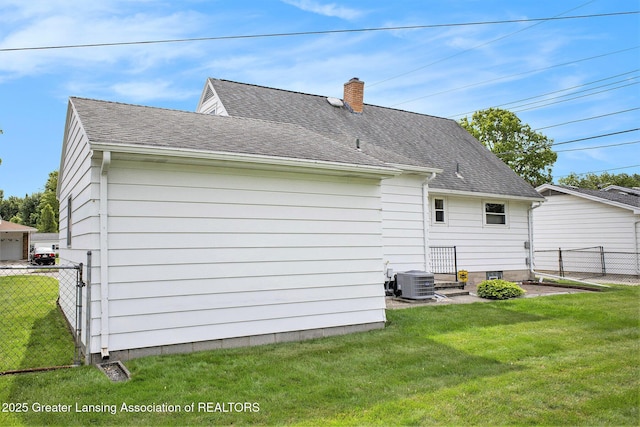 4810 Cherryland Dr, Lansing, MI 48910 - back of property featuring central AC, a chimney, roof with shingles, and a gate