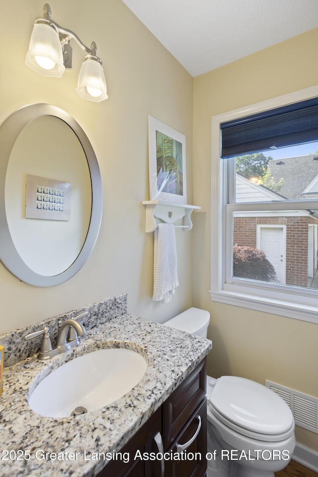 438 Bailey St, East Lansing, MI 48823 - bathroom featuring vanity and toilet