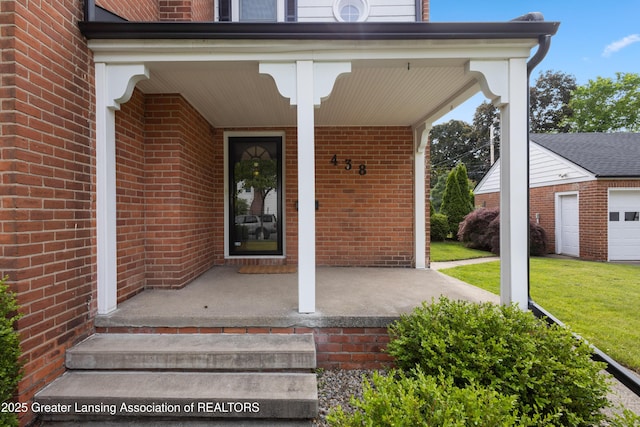 438 Bailey St, East Lansing, MI 48823 - property entrance with a porch, brick siding, and a lawn