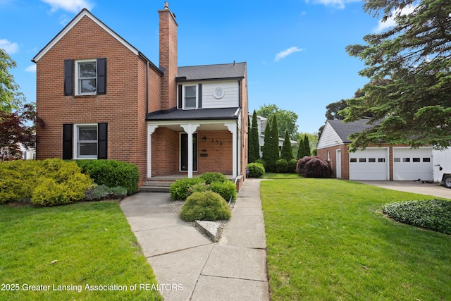 438 Bailey St, East Lansing, MI 48823 - traditional-style house featuring a porch, a chimney, a front yard, and brick siding