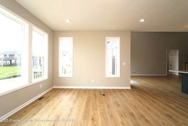 615 Magenta Ct, Haslett, MI 48840 - spare room featuring wood finished floors, baseboards, and recessed lighting