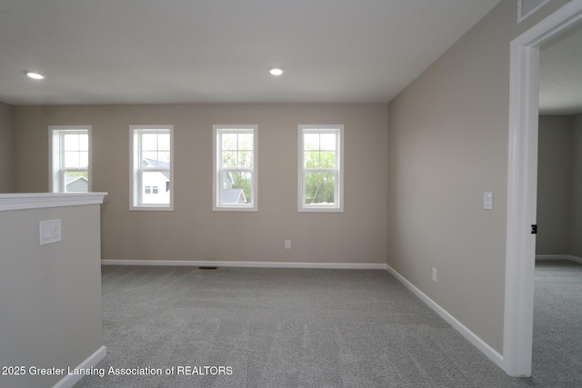 615 Magenta Ct, Haslett, MI 48840 - carpeted empty room with plenty of natural light, baseboards, and recessed lighting