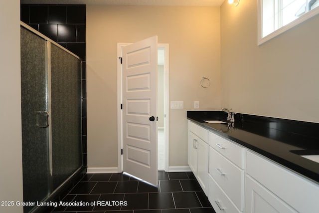 615 Magenta Ct, Haslett, MI 48840 - bathroom featuring double vanity, a stall shower, tile patterned flooring, and baseboards