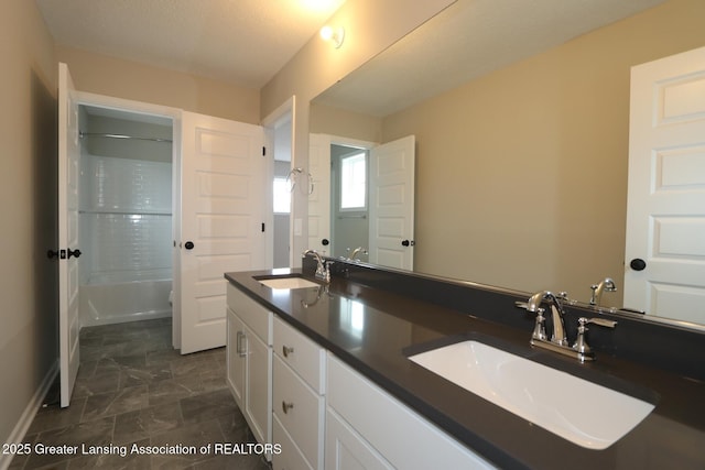 615 Magenta Ct, Haslett, MI 48840 - bathroom featuring double vanity, baseboards, and shower / tub combination