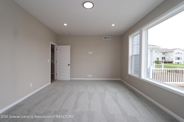 615 Magenta Ct, Haslett, MI 48840 - empty room with baseboards, light carpet, and recessed lighting