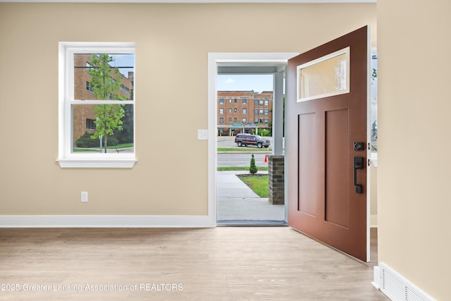 1221 W Saginaw St, Lansing, MI 48915 - entryway featuring light wood-style floors and baseboards