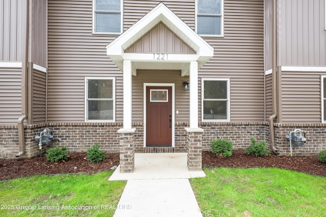 1221 W Saginaw St, Lansing, MI 48915 - view of exterior entry featuring brick siding and board and batten siding