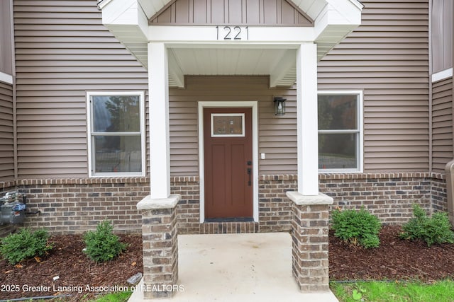1221 W Saginaw St, Lansing, MI 48915 - entrance to property with brick siding and board and batten siding