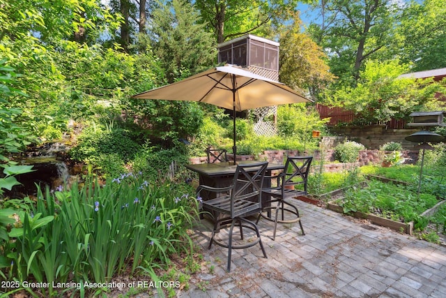 2146 Tecumseh River Rd, Lansing, MI 48906 - view of patio / terrace featuring outdoor dining space and a sunroom
