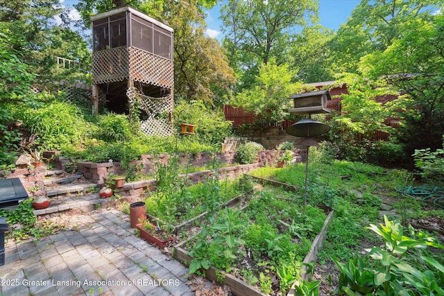 2146 Tecumseh River Rd, Lansing, MI 48906 - view of yard featuring a garden and a sunroom