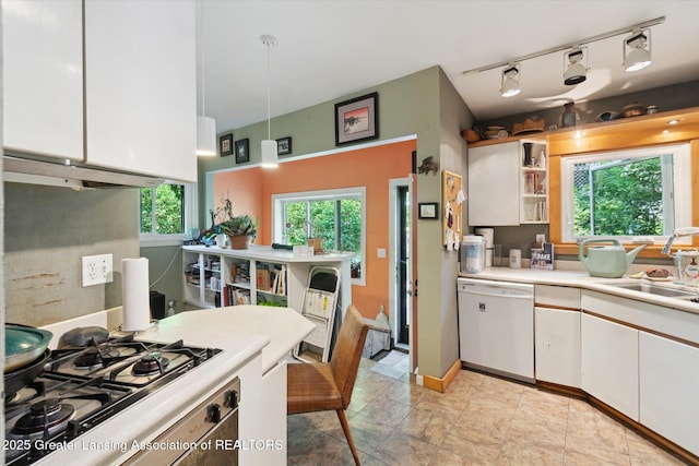 2146 Tecumseh River Rd, Lansing, MI 48906 - kitchen with white dishwasher, gas cooktop, white cabinets, light countertops, and rail lighting