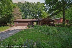2146 Tecumseh River Rd, Lansing, MI 48906 - view of front of house with an attached garage and driveway