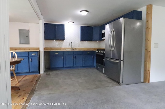 5413 S Waverly Rd, Lansing, MI 48911 - kitchen with stainless steel appliances, electric panel, blue cabinets, a sink, and decorative backsplash