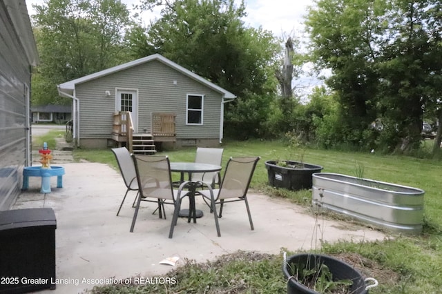 5413 S Waverly Rd, Lansing, MI 48911 - view of patio with outdoor dining area and a wooden deck
