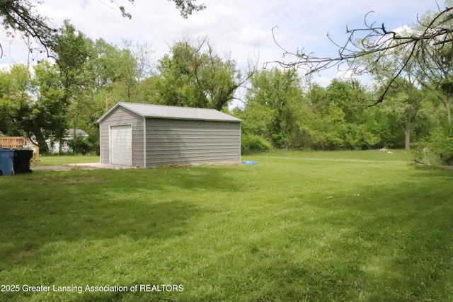5413 S Waverly Rd, Lansing, MI 48911 - view of green lawn featuring an outdoor structure and a detached garage