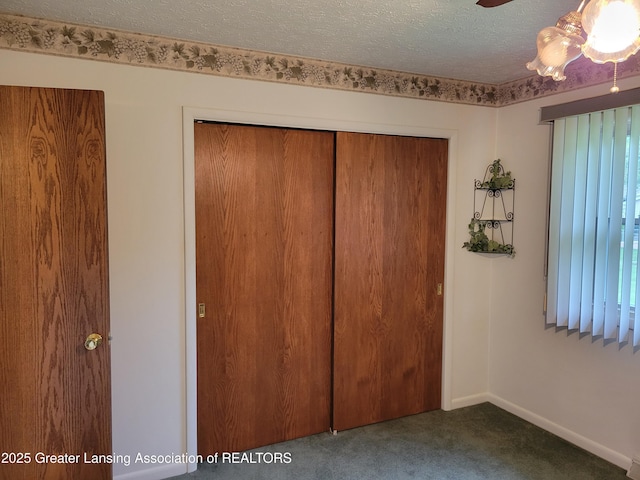 718 W Shepherd St, Charlotte, MI 48813 - unfurnished bedroom with carpet floors, a closet, a textured ceiling, and baseboards
