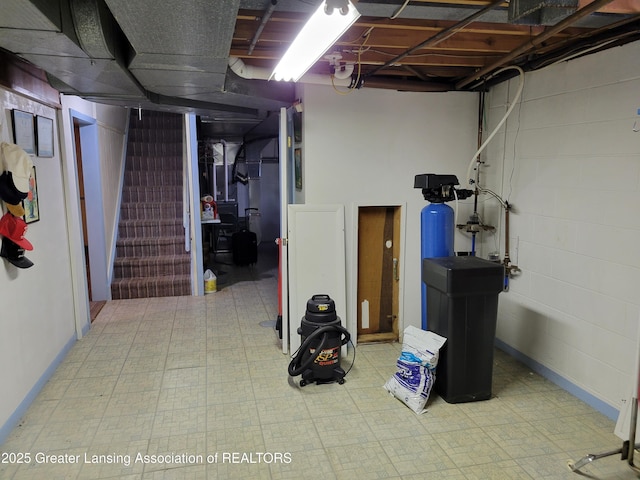 718 W Shepherd St, Charlotte, MI 48813 - basement featuring a water softener, tile patterned floors, and stairs