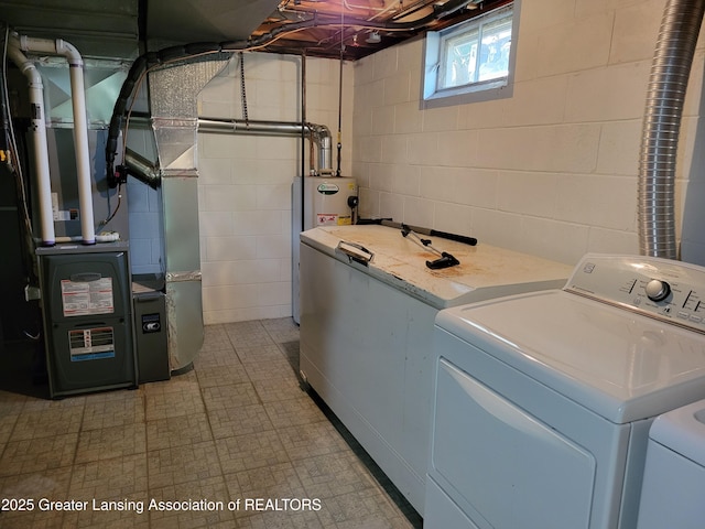 718 W Shepherd St, Charlotte, MI 48813 - laundry room with washing machine and dryer, electric water heater, and concrete block wall