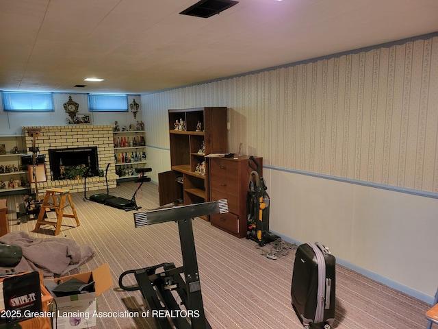 718 W Shepherd St, Charlotte, MI 48813 - exercise room with carpet floors and a brick fireplace